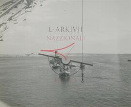 Boats and a crane surrounding British military plane Walrus after crashing into the sea